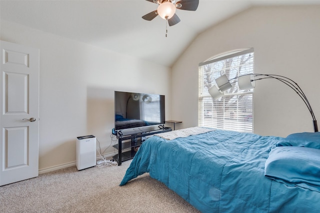 carpeted bedroom with baseboards, vaulted ceiling, and a ceiling fan