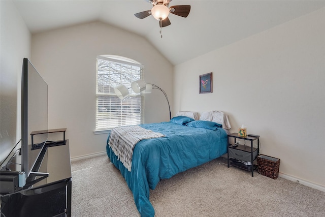 bedroom featuring carpet floors, vaulted ceiling, baseboards, and ceiling fan