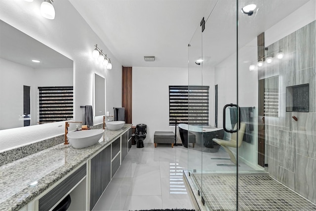 bathroom with an enclosed shower, vanity, and tile patterned floors