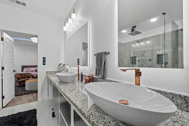 bathroom with tile patterned flooring, vanity, and an enclosed shower