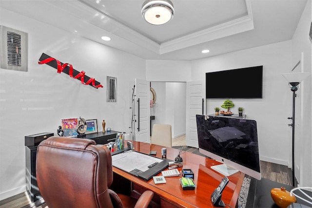 office area featuring ornamental molding, wood-type flooring, and a tray ceiling