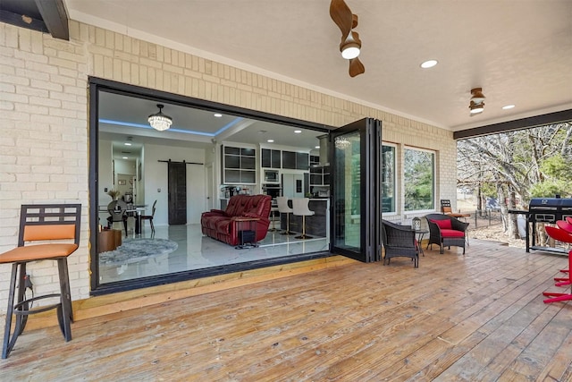 deck with area for grilling and ceiling fan