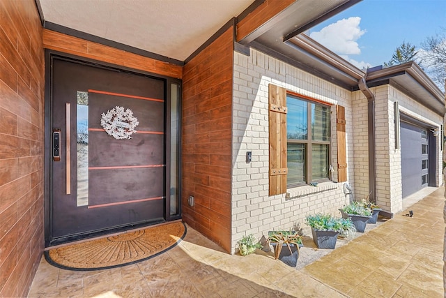 view of exterior entry with a garage