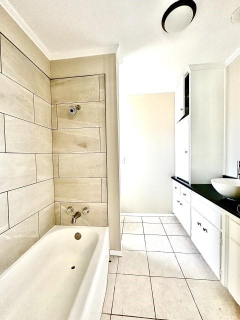 bathroom featuring crown molding, tile patterned floors, vanity, and a bath