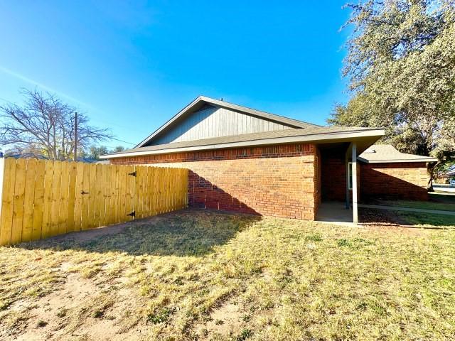 view of property exterior featuring a lawn