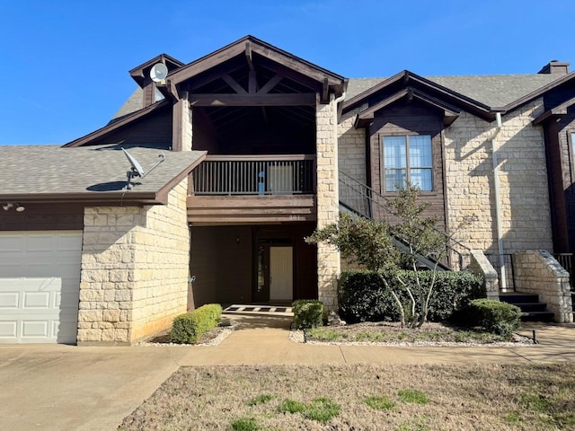 view of front of home featuring a garage and a balcony