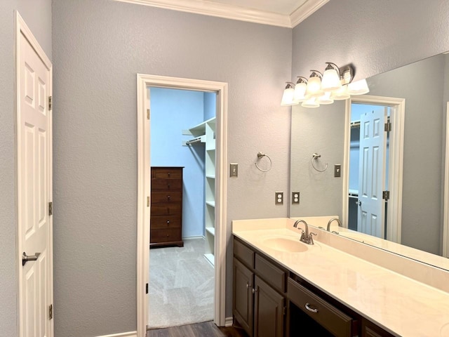 bathroom with ornamental molding and vanity