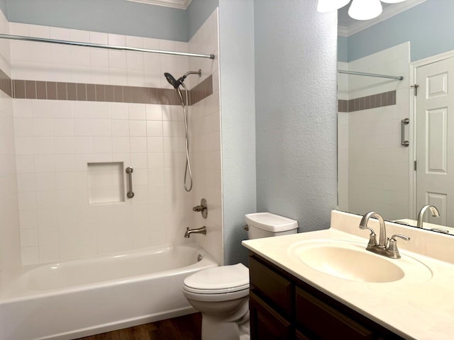 full bathroom featuring wood-type flooring, tiled shower / bath combo, vanity, toilet, and crown molding