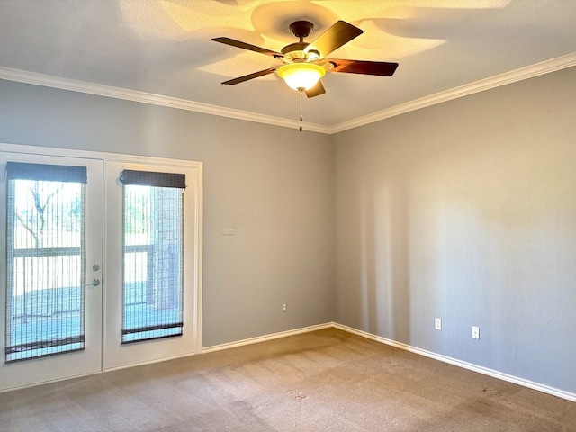 unfurnished room featuring carpet floors, ornamental molding, french doors, and ceiling fan