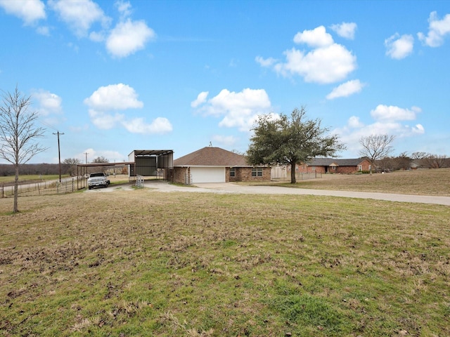 view of front facade featuring a carport, a garage, and a front lawn