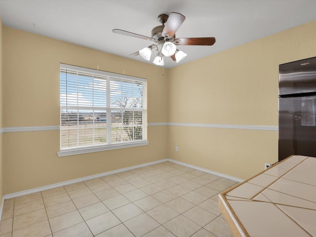 interior space with ceiling fan