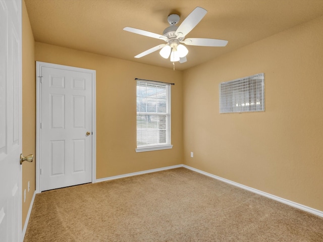 spare room with carpet flooring and ceiling fan