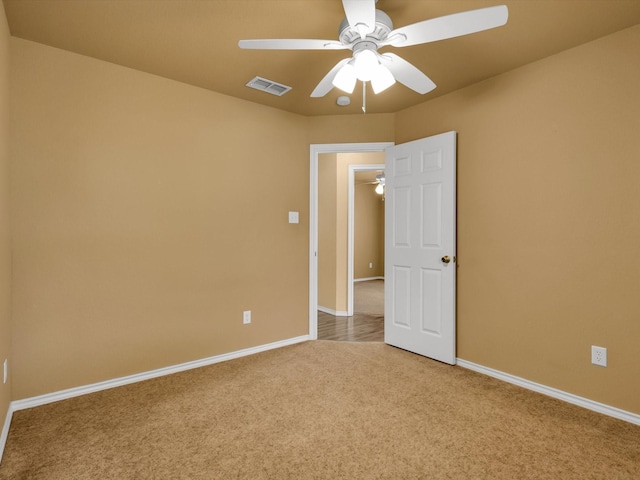 spare room featuring ceiling fan and light colored carpet