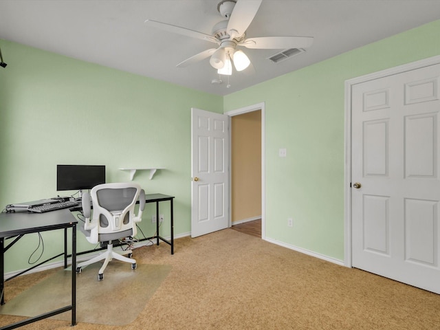 office area featuring ceiling fan and light carpet