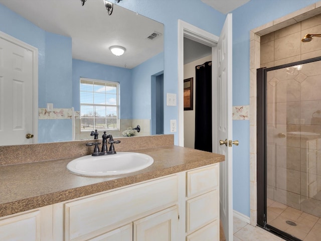 bathroom with tile patterned floors, vanity, and a shower with door