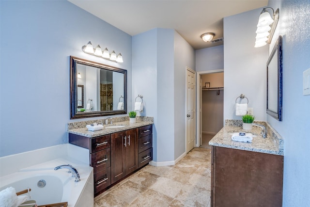 bathroom with vanity and a washtub