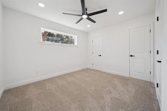 carpeted spare room with ceiling fan