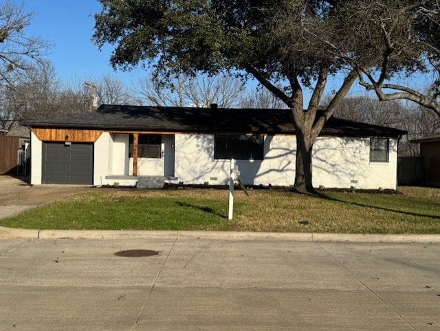 ranch-style house featuring a garage and a front yard