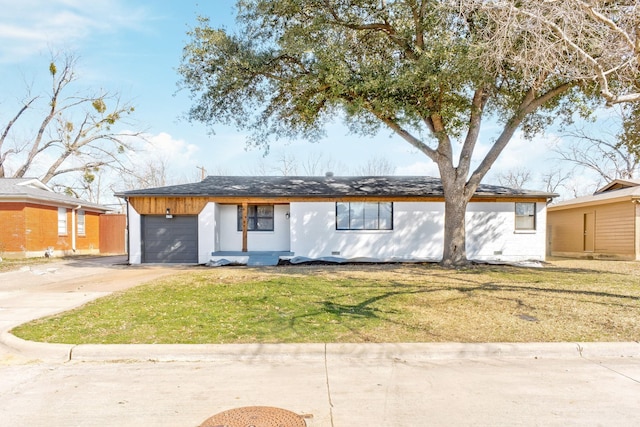 view of front facade with a garage, concrete driveway, and a front yard