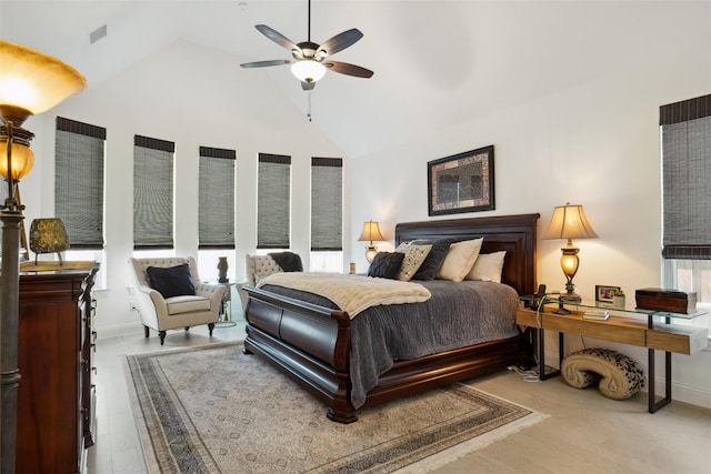 bedroom with lofted ceiling, ceiling fan, and light wood-type flooring