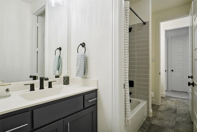 bathroom featuring tiled shower / bath combo and vanity