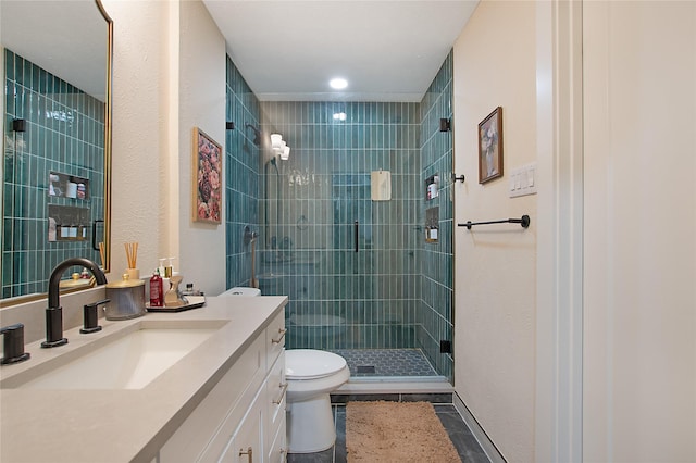 bathroom with a shower with door, vanity, and toilet