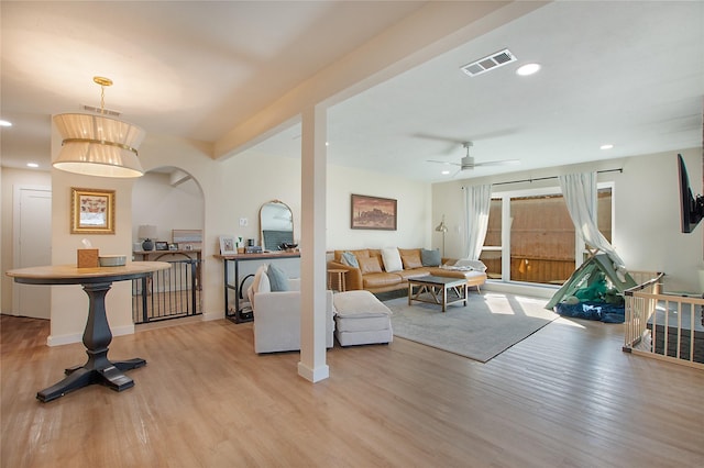 living room featuring light hardwood / wood-style flooring and ceiling fan