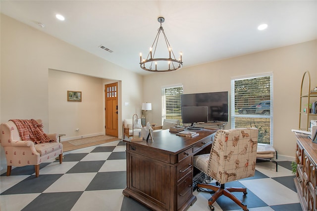 office space with lofted ceiling and an inviting chandelier