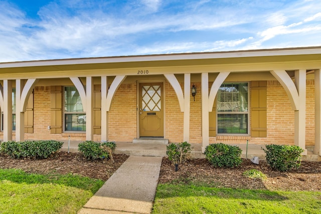 view of exterior entry featuring a porch