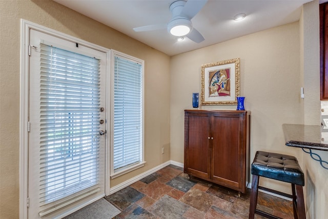 doorway to outside featuring ceiling fan