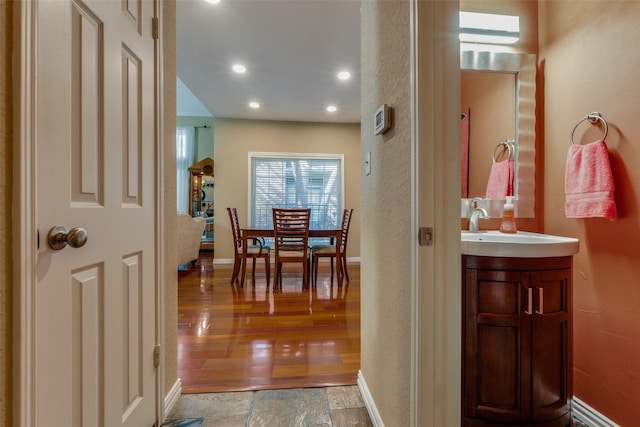 hallway featuring sink and light wood-type flooring