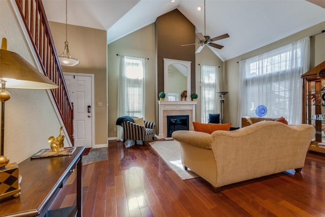 living room featuring ceiling fan, dark hardwood / wood-style floors, and high vaulted ceiling