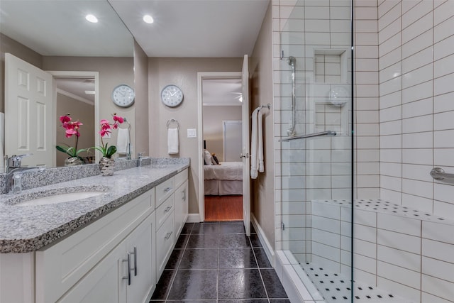 bathroom featuring vanity, tiled shower, and tile patterned floors