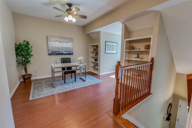 home office with wood-type flooring, built in features, and ceiling fan