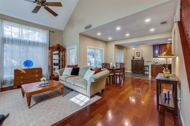 living room with high vaulted ceiling, dark hardwood / wood-style floors, and ceiling fan