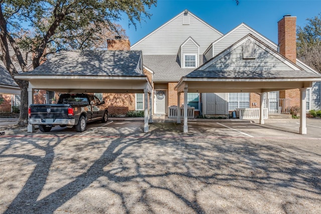 view of front facade featuring a carport and a storage unit