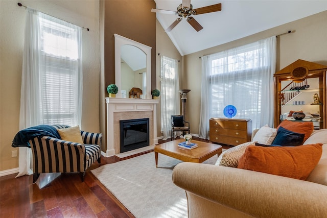 living room with plenty of natural light, high vaulted ceiling, dark hardwood / wood-style floors, and ceiling fan