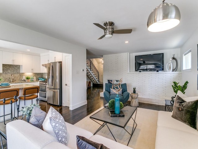 living area featuring stairs, dark wood finished floors, a ceiling fan, and recessed lighting