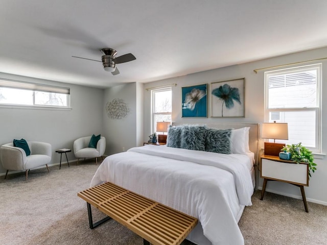 carpeted bedroom with ceiling fan and baseboards