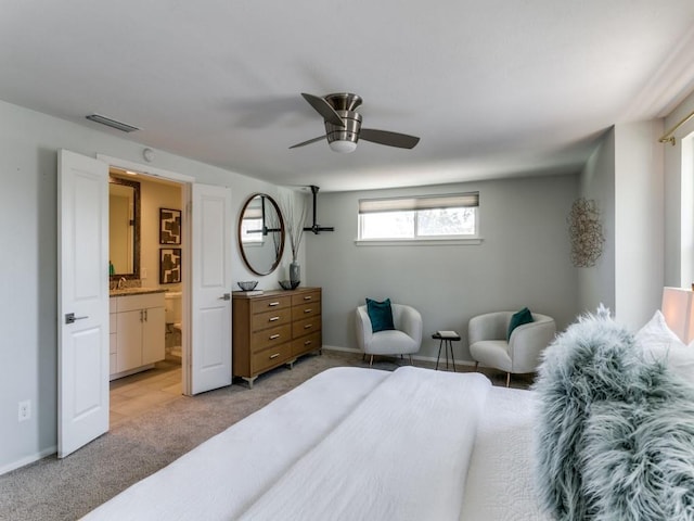 bedroom featuring visible vents, light carpet, connected bathroom, ceiling fan, and baseboards