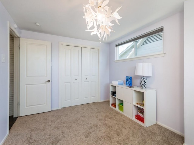 recreation room with baseboards, carpet, and an inviting chandelier