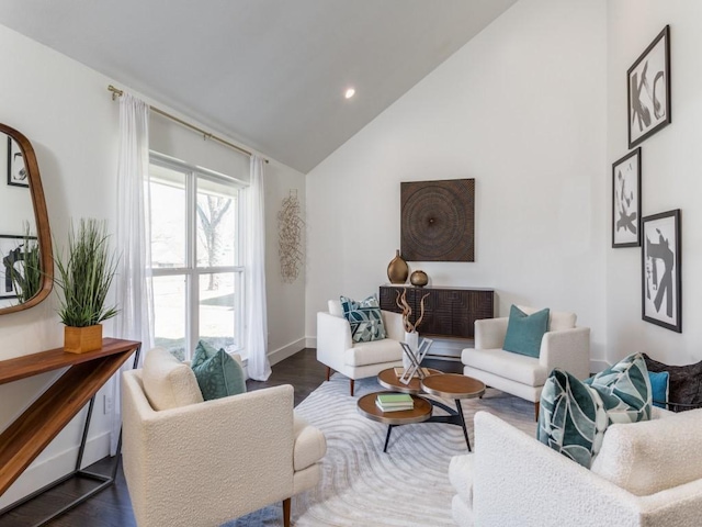 living area with high vaulted ceiling, recessed lighting, baseboards, and wood finished floors