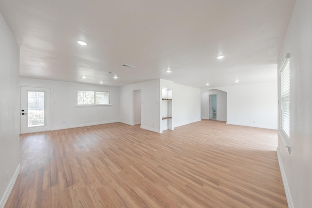 empty room with light hardwood / wood-style flooring