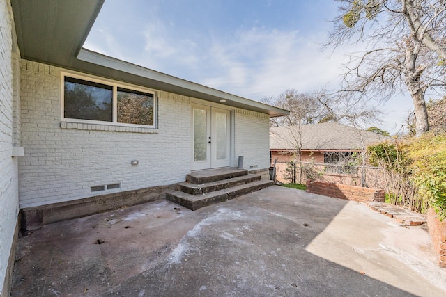 entrance to property with a patio area and french doors