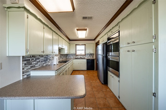 kitchen with sink, crown molding, tasteful backsplash, black appliances, and a textured ceiling