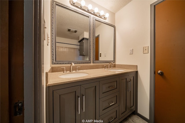 bathroom with vanity and a textured ceiling