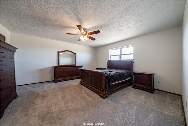 bedroom featuring ceiling fan, carpet floors, and a textured ceiling