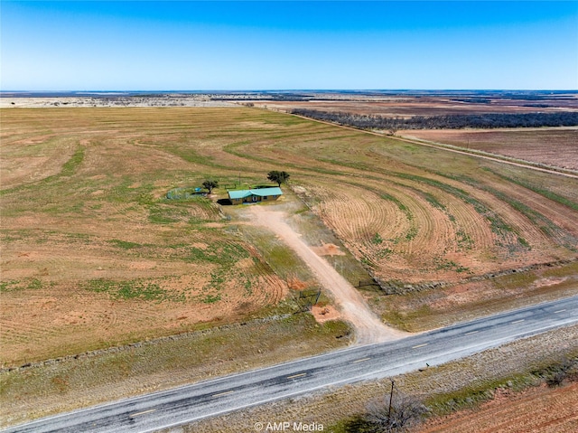 birds eye view of property with a rural view