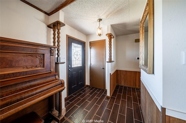 foyer entrance with a textured ceiling