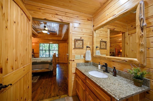 bathroom with hardwood / wood-style flooring, vanity, ceiling fan, and wood ceiling